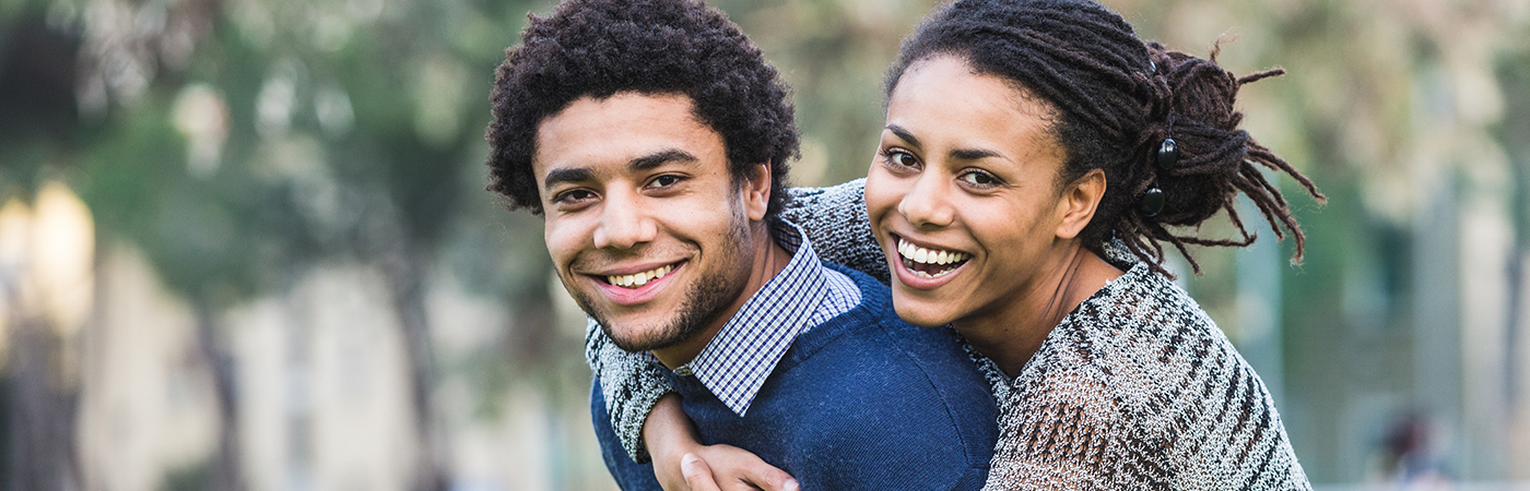 Close up of man giving woman a piggyback ride